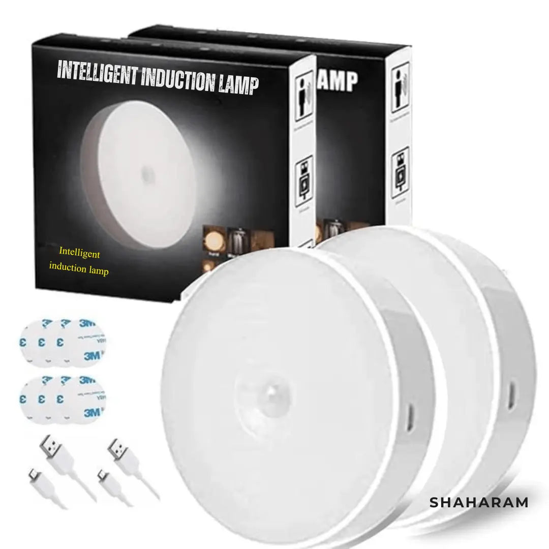 Pack of 2 smart motion sensor night lights with product boxes, USB charging cables, and adhesive sticky pads.